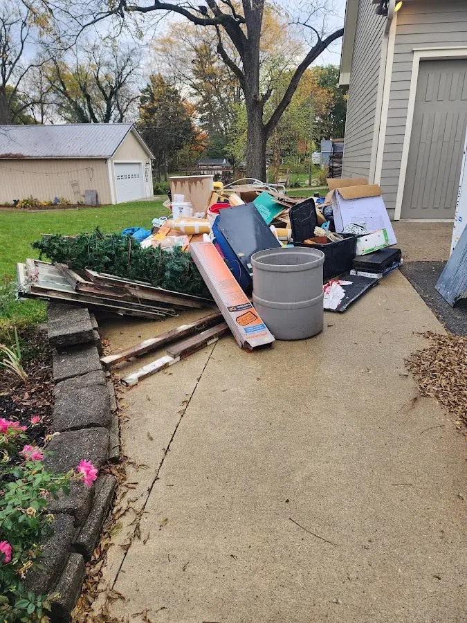 Dumpster being loaded with debris for Demolition Dumpster Rental in West Gardiner